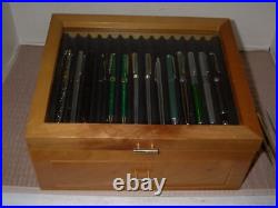 Mint Display Case with Pens and Pencils in it