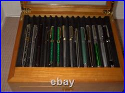 Mint Display Case with Pens and Pencils in it