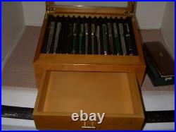 Mint Display Case with Pens and Pencils in it
