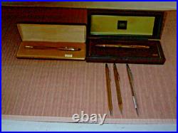 Mint Display Case with Pens and Pencils in it